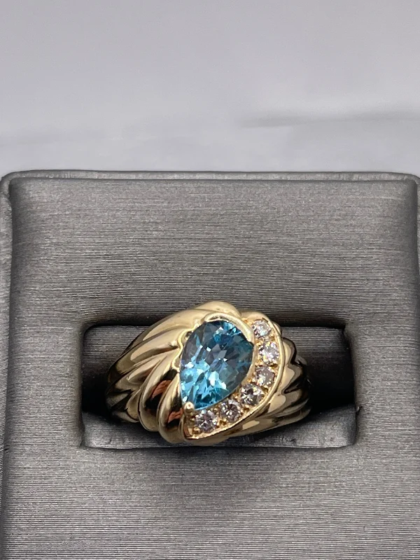 14 Karat Yellow Gold Fluted Band Pear Shaped Blue Topaz And Diamond Ring