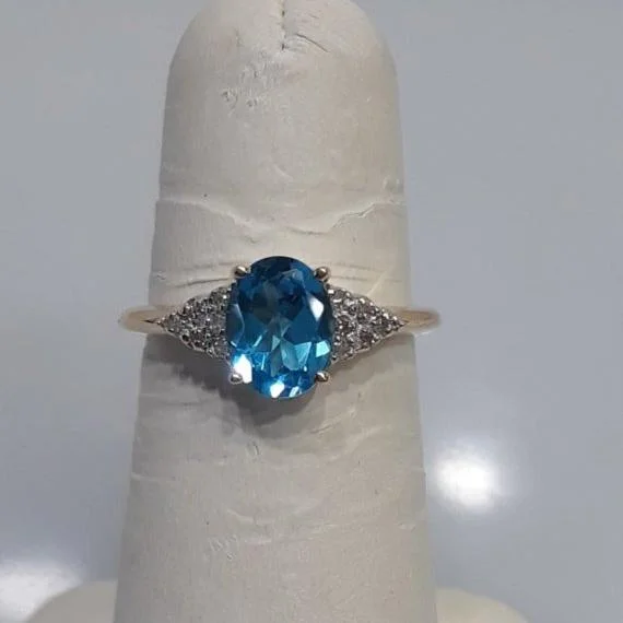 14 Karat Yellow Gold Oval Blue Topaz And Diamond Ring